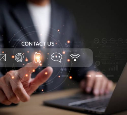 Businessman using a laptop and touching on virtual screen contact icons consists of telephone, email, address, live chat, internet wifi, Contact us or Customer care support hotline people connect.